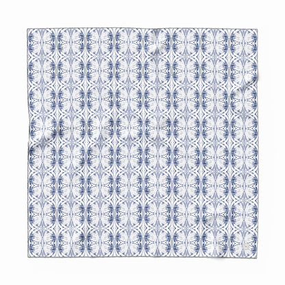Silk scarf featuring a hand-painted blue and white pattern.