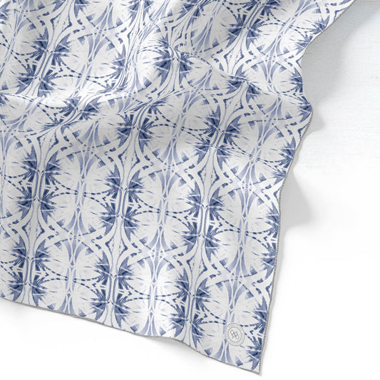 Silk scarf featuring a hand-painted blue and white pattern.