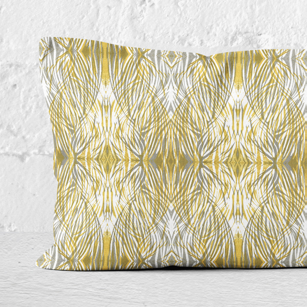 Detail of a 12 x 24 lumbar pillow featuring a gold and gray abstract linocut pattern.