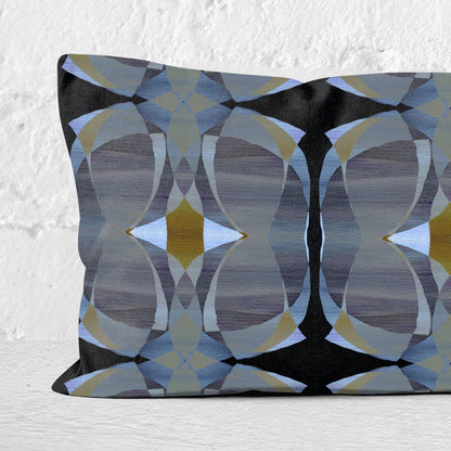 Detail of a rectangular lumbar pillow featuring a hand-painted pattern in black, grey, and gold tones.
