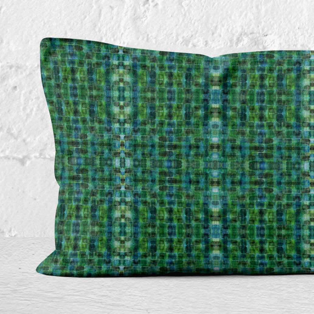 Detail of a rectangular lumbar pillow featuring a hand-painted abstract plaid pattern in kelly green.
