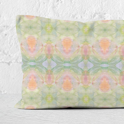 Detail of lumbar pillow featuring a hand-painted abstract pattern in pastel colors.