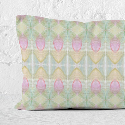 Detail of a rectangular pillow featuring a hand-painted abstract rosebud pattern.