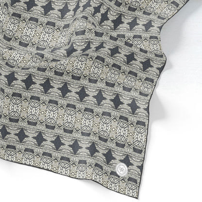 Silk scarf featuring an abstract geometric pattern in gray and black.