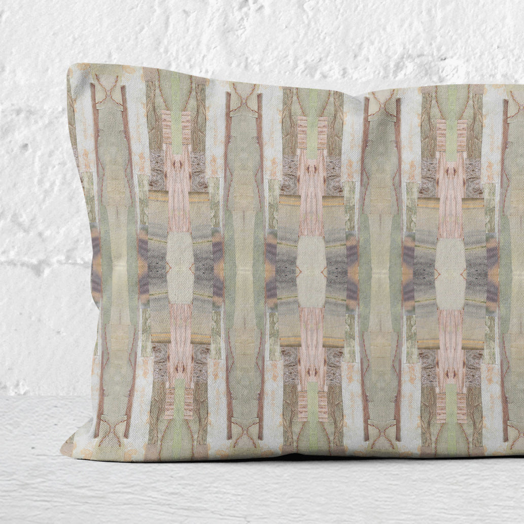 Detail of a 12 x 24 pillow featuring a pink, green, and beige cut paper collage pattern