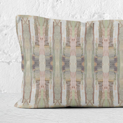 Detail of a 12 x 24 pillow featuring a pink, green, and beige cut paper collage pattern