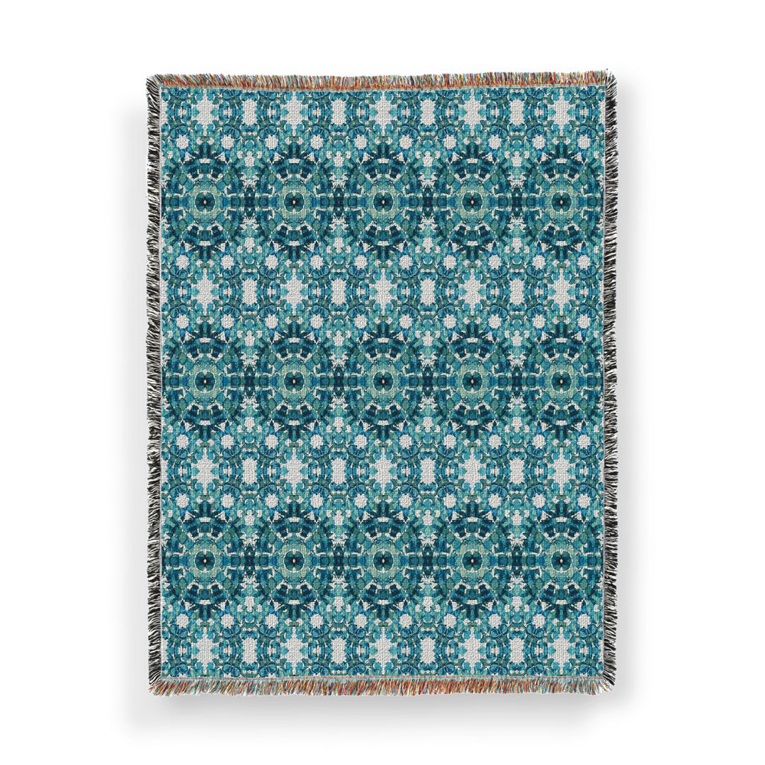 Cotton woven throw blanket featuring a teal hand-painted pattern