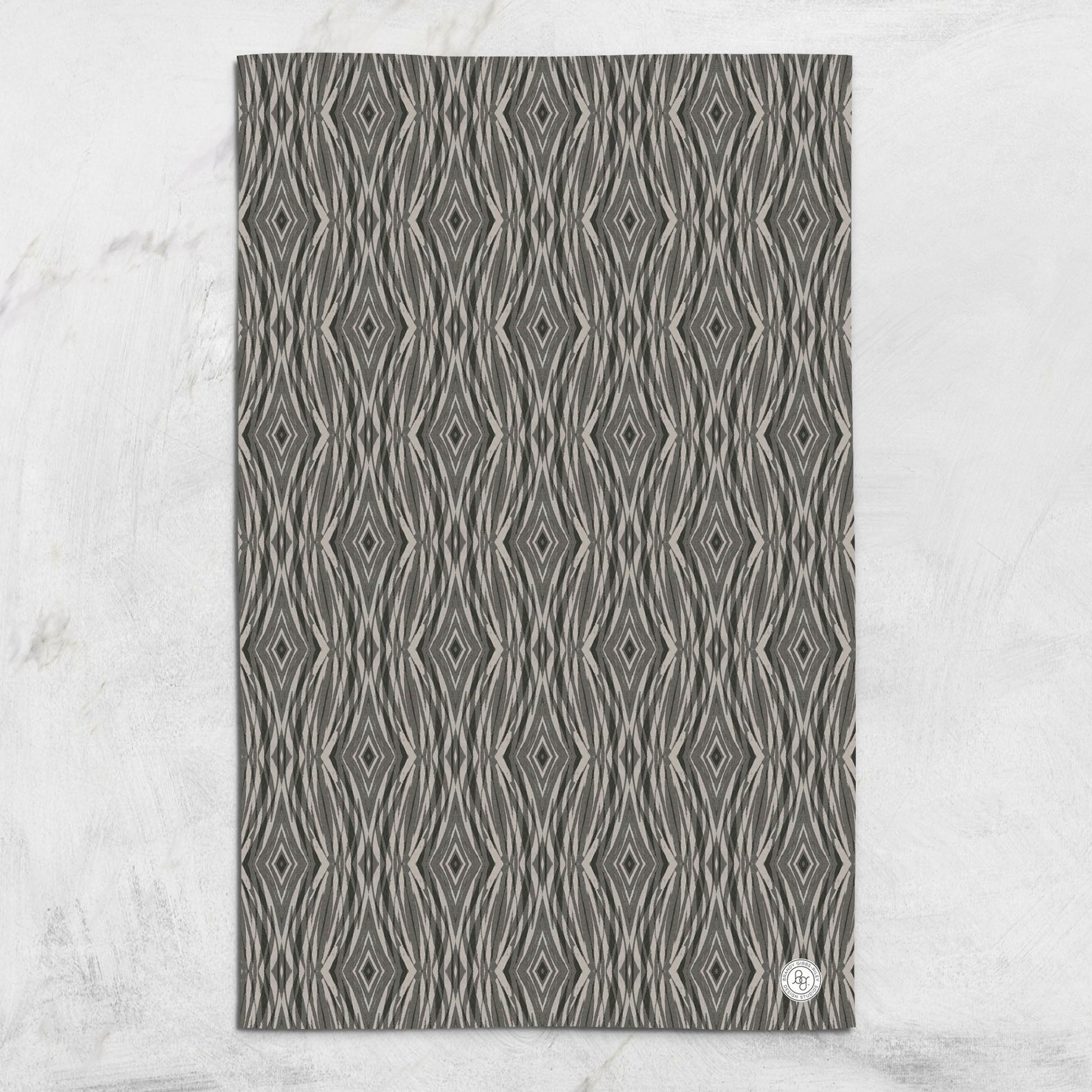 Organic cotton hemp tea towel featuring a hand-designed, linocut abstract pattern in grey and beige.